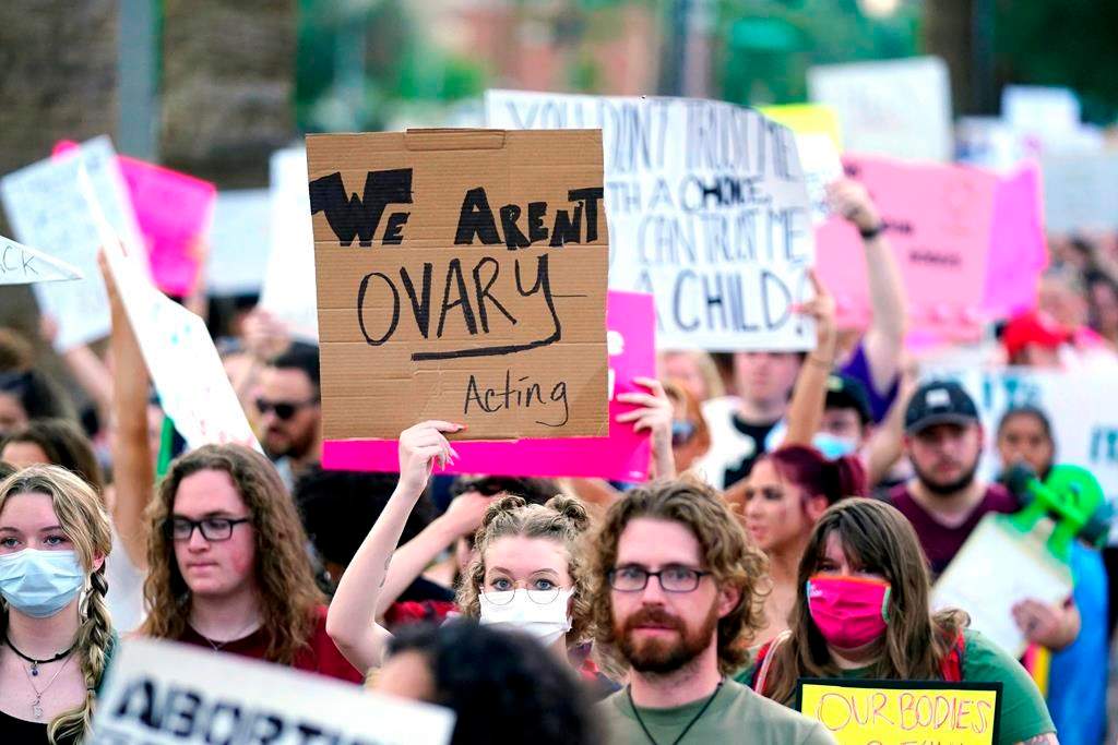 Thousands of protesters march around the Arizona Capitol after the Supreme Court decision to overturn the landmark Roe v. Wade abortion decision Friday, June 24, 2022, in Phoenix. The Supreme Court on Friday stripped away women’s constitutional protections for abortion, a fundamental and deeply personal change for Americans' lives after nearly a half-century under Roe v. Wade. The court’s overturning of the landmark court ruling is likely to lead to abortion bans in roughly half the states. (AP Photo/Ross D. Franklin).