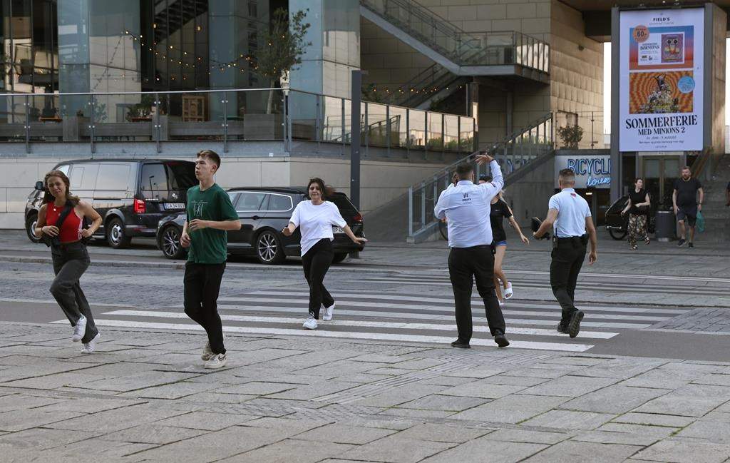 People evacuated from the Field’s shopping center run, in Orestad, Copenhagen, Denmark, Sunday, July 3, 2022, after reports of shots fired.