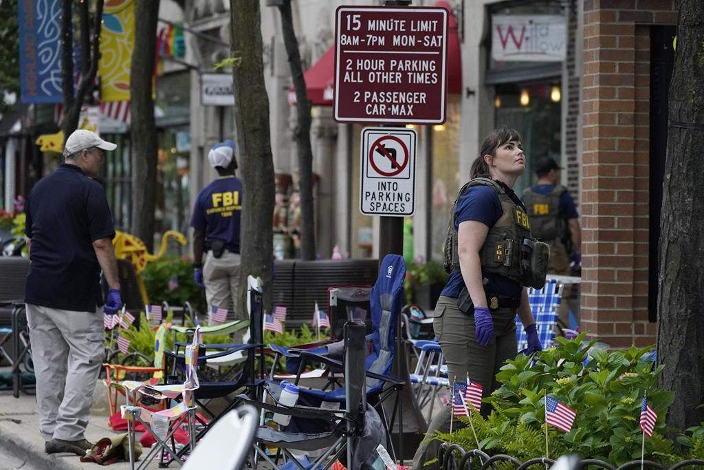 Law enforcement conduct a search after a mass shooting at the Highland Park Fourth of July parade in downtown Highland Park, Ill., a Chicago suburb on Monday, July 4, 2022.