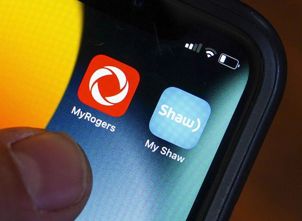 Rogers and Shaw applications are pictured on a cellphone in Ottawa on Monday, May 9, 2022.