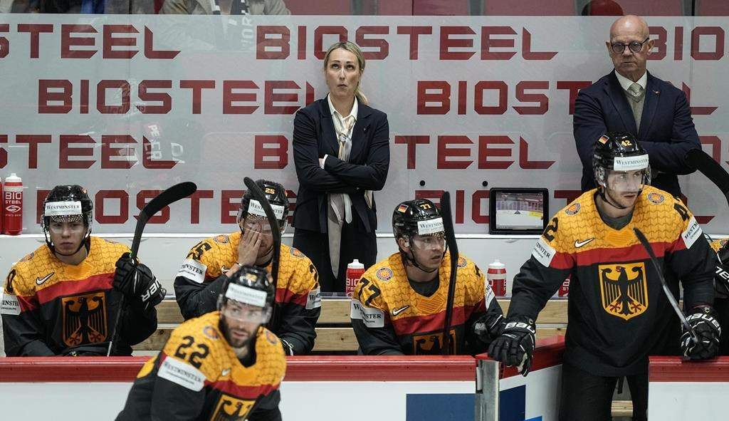Germany’s assistant coaches Jessica Campbell and Tom Rowe, from left, stand behind players at the German bench during the group A Hockey World Championship match between France and Germany in Helsinki, Finland, Monday May 16, 2022. The Coachella Valley Firebirds have hired Campbell, the American Hockey League’s first female assistant coach. THE CANADIAN PRESS/AP-Martin Meissner