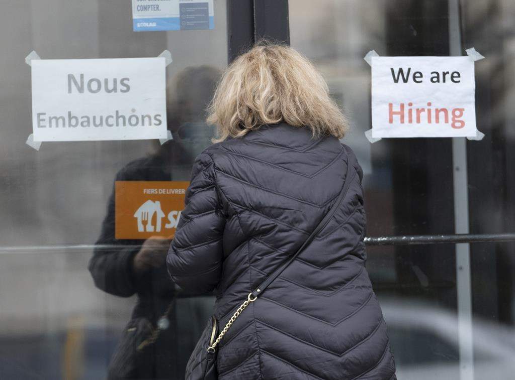 A customer enters a restaurant with help wanted signs Wednesday, November 17, 2021 in Laval.