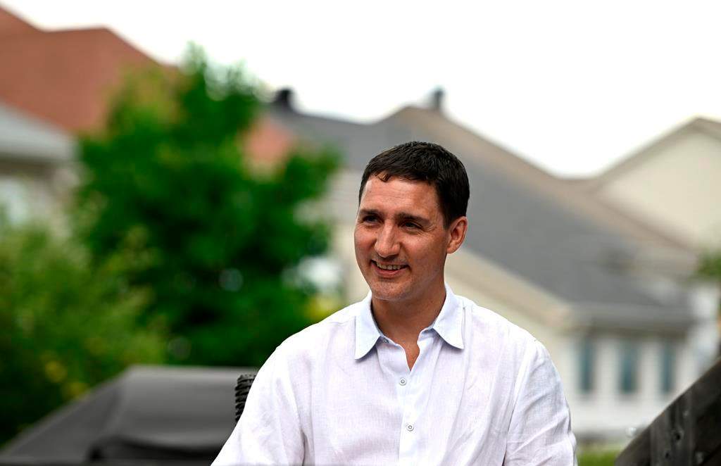Prime Minister Justin Trudeau speaks to a family about the Climate Action Incentive Payment at their home in Ottawa on Friday, July 15, 2022. Prime Minister Justin Trudeau's day of whistle stops in the Ottawa area ended early Friday as anti-Liberal protesters gathered outside a brewery before he arrived. 