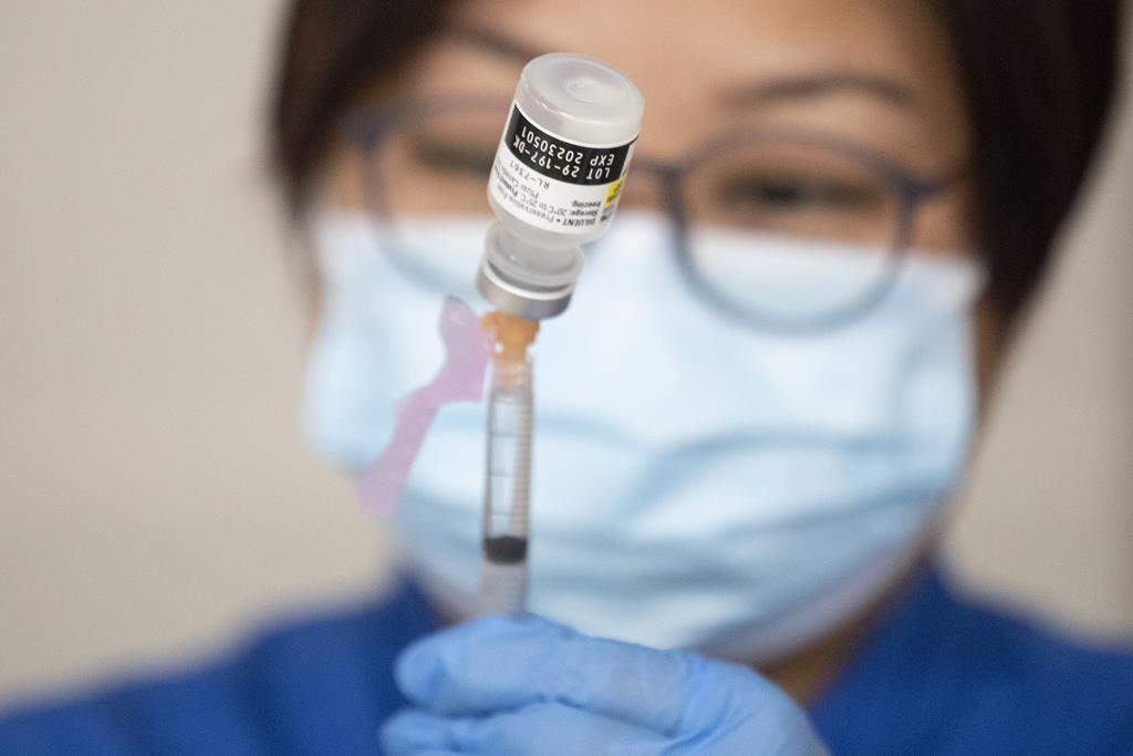 Nurse prepares COVID-19 vaccine
