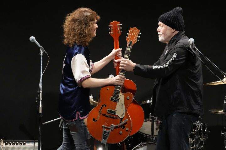 Canadian rock legend Randy Bachman, right, receives his stolen Gretsch guitar during the Lost and Found Guitar Exchange Ceremony Friday, July 1, 2022, at Canadian Embassy in Tokyo.