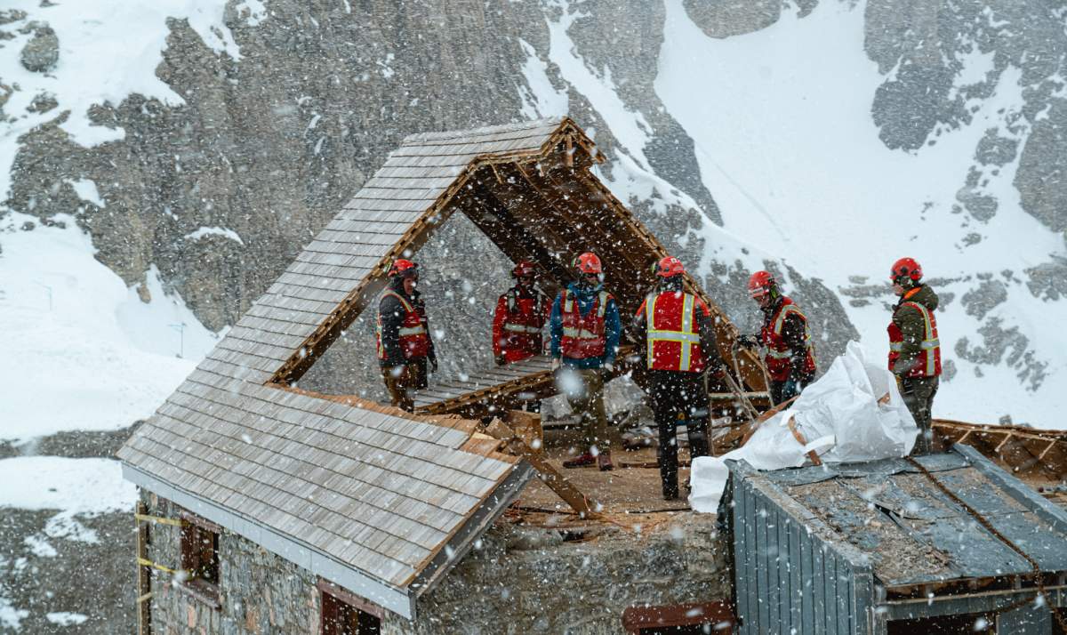 Workers dismantle the Abbot Pass Refuge Cabin in this undated handout photo. Parks Canada says a hut built by Swiss guides a century ago in the Rockies has been substantially removed.