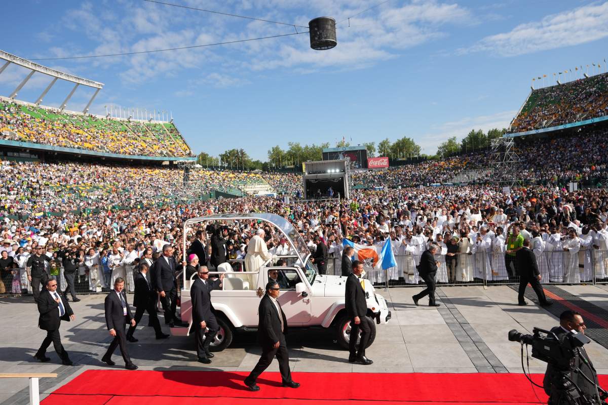 Pope Francis waves as he arrives to take part in a public mass at Commonwealth Stadium in Edmonton, Tuesday, July 26, 2022.