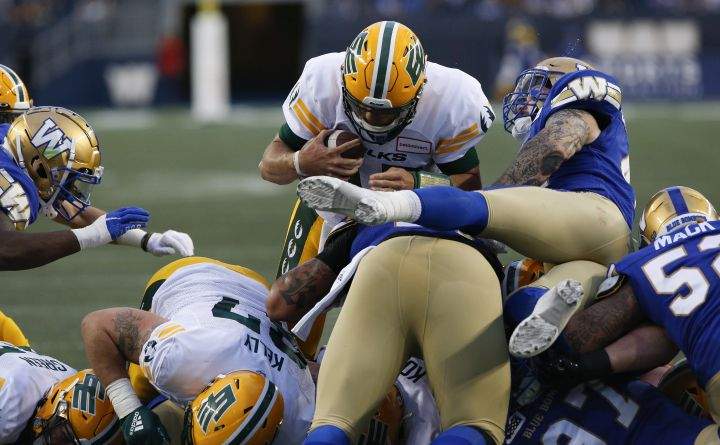 Edmonton Elks quarterback Taylor Cornelius (15) drives through for the touchdown against the Winnipeg Blue Bombers during the first half of pre-season CFL action in Winnipeg, Friday, May 27, 2022. 