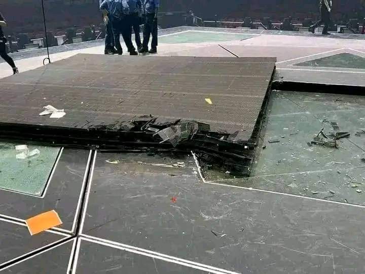 The smashed screen laying on stage where it had fallen.