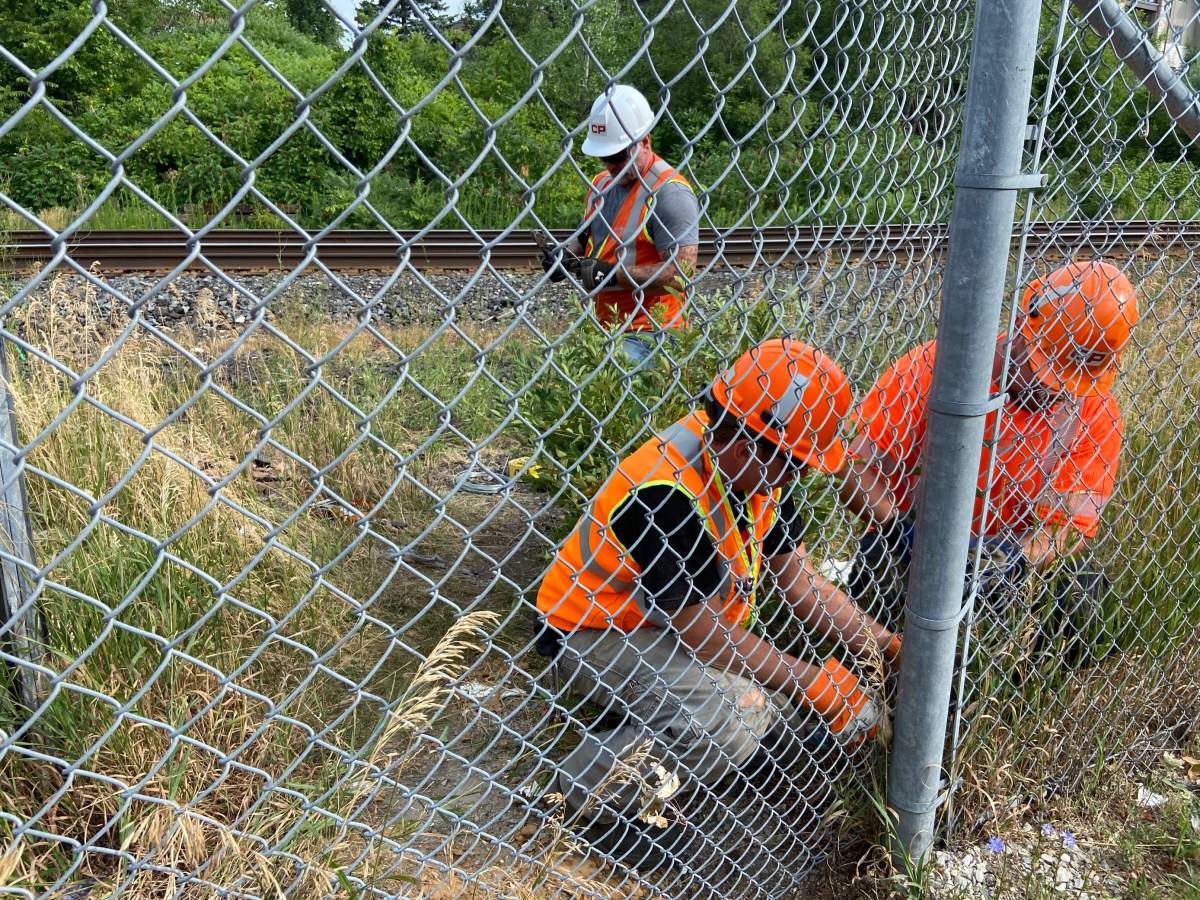 Crews are seen patching up the fence.