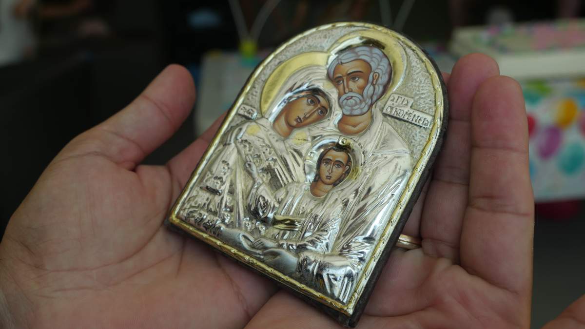 Kostenko Oleksandr holding his family saint item.