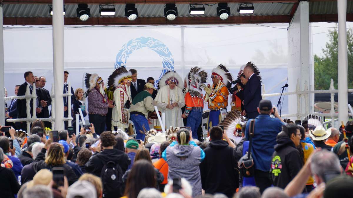 Pope Francis dons an eagle feather headdress gifted to him after his apology for residential schools in Maskwacis, Alta. on Mon. July 25, 2022.