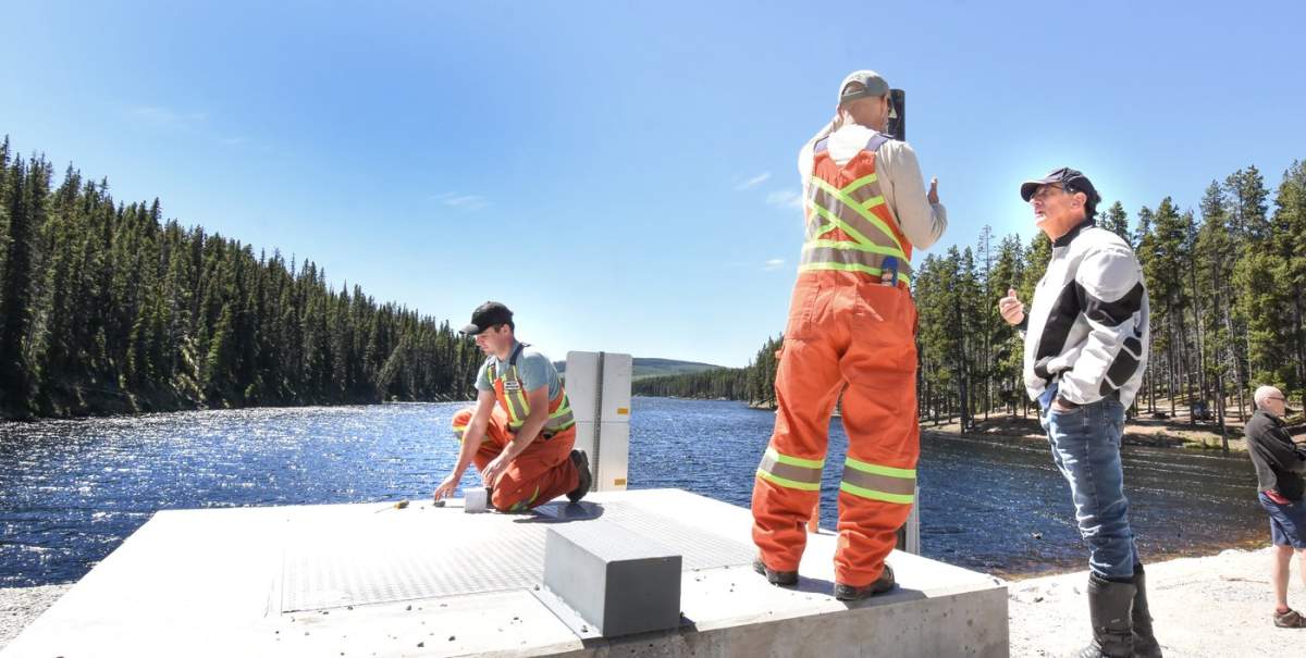 Penticton MLA Dan Ashton talks with a Summerland municipal worker at the Isintok Dam opening on Tuesday.