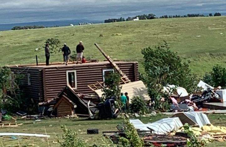 A photo of a log house west of Medicine Hat, Alta., on July 18, 2022. The home was missing its upper level after a storm tore through the area.