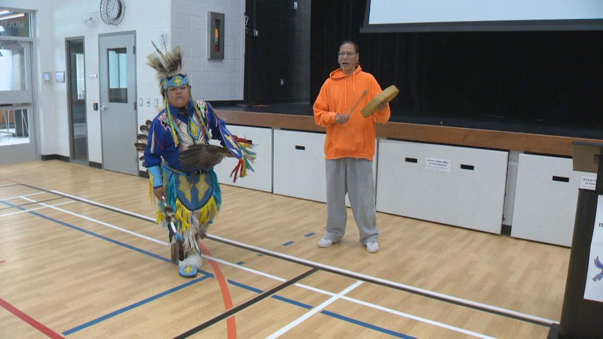 Sunray Kahnapace blesses the ground with a traditional warrior dance, while Jason Littletent plays an honour song.