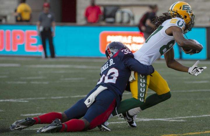 Montreal Alouettes' Rodney Randle Jr. tackles Edmonton Elks' Derel Walker during frist half CFL action in Montreal on Thursday July 14, 2022. 