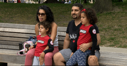 A family enjoys Canada Day celebrations in St. James Park in Toronto.