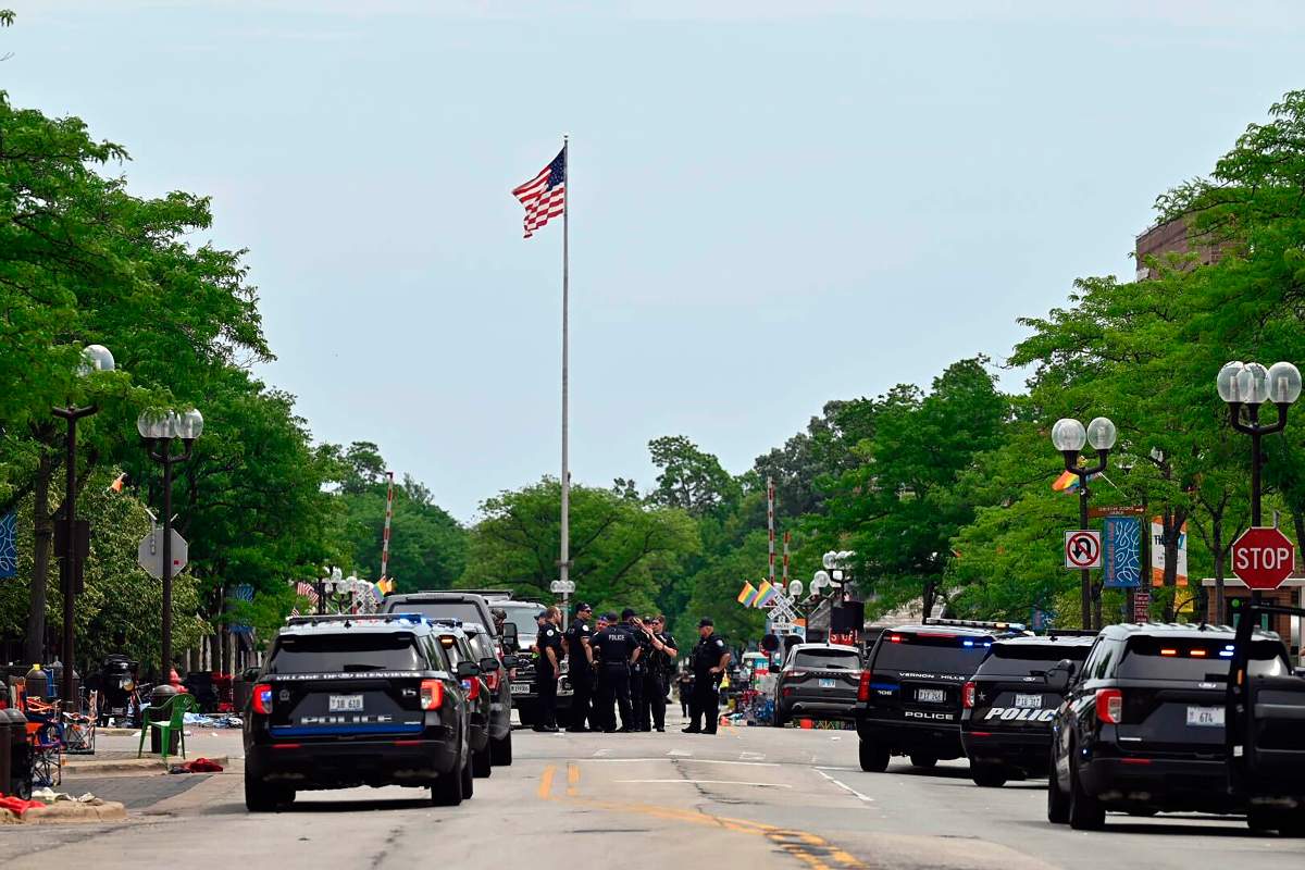 Police from several local municipalities including the Illinois State Police search downtown Highland Park after the mass shooting at the Fourth of July parade Monday, July 4, 2022 in Chicago.