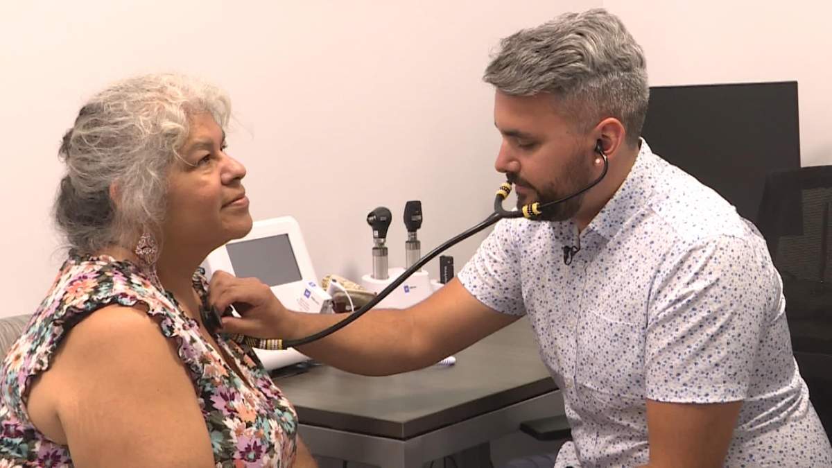 Dr. Brent Young checks heartbeat of patient Charlotte Bernard.