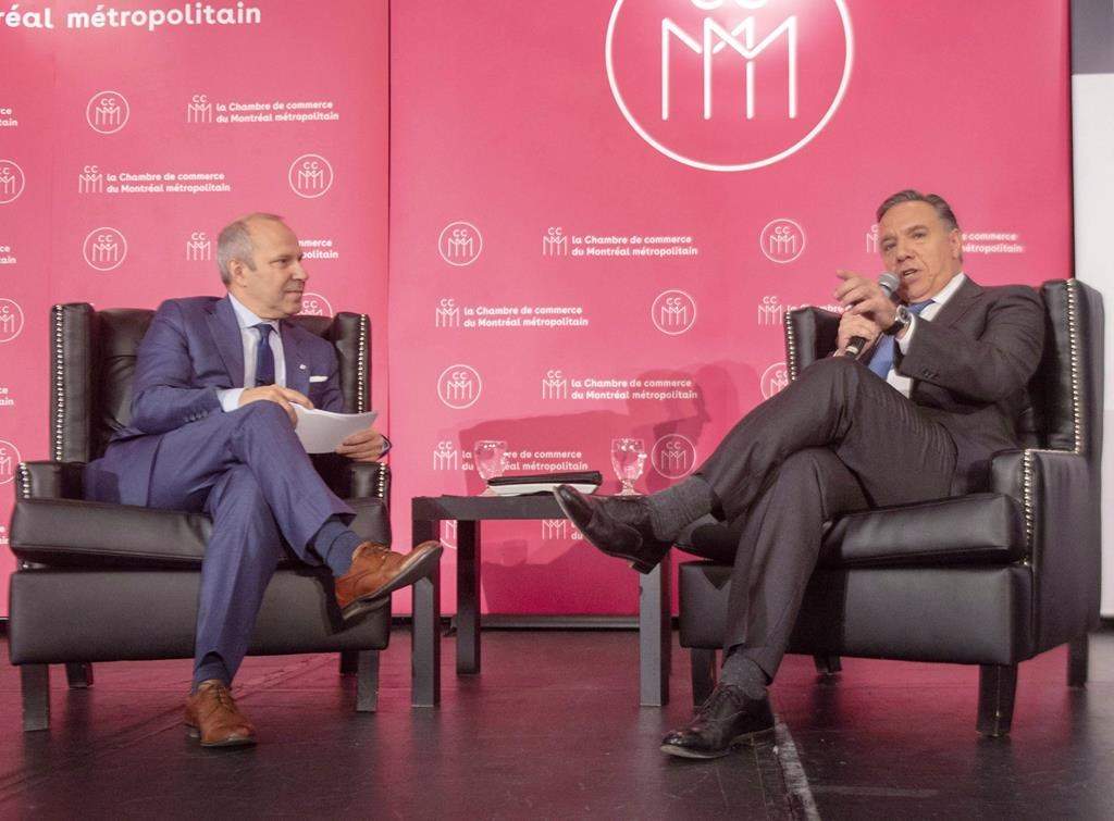 Coalition Avenir du Québec leader François Legault, right, speaks to Chamber of Commerce President Michel Leblanc on Sept. 28, 2018, in Montreal.