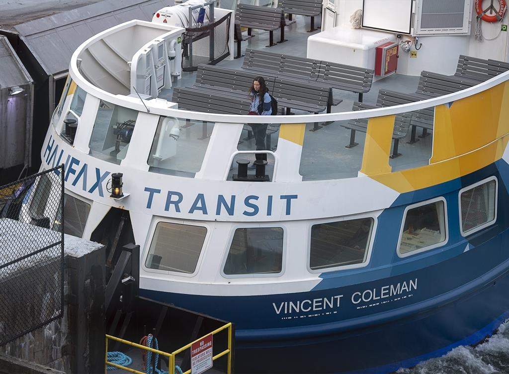 A person stands on the deck of the ferry Vincent Coleman at the terminal in Dartmouth, N.S., on March 16, 2020. THE CANADIAN PRESS/Andrew Vaughan.