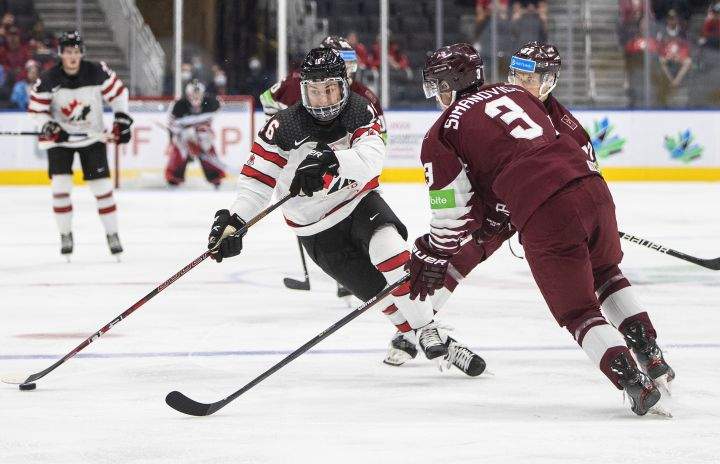 Canada’s Connor Bedard (16) makes a move past Latvia’s Rihards Simanovics (3) during second period IIHF World Junior Hockey Championship action in Edmonton on Wednesday, August 10, 2022.