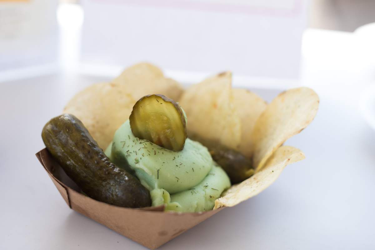 A sample of the Pickle Split from vendor Dole Whip Soft Serve/ Black Halo Ice Cream, is photographed during the media preview event for the the Canadian National Exhibition in Toronto, on Wednesday, August 17, 2022. The banana split inspired food creation features pickle flavoured soft serve between two pickles. THE CANADIAN PRESS/Tijana Martin