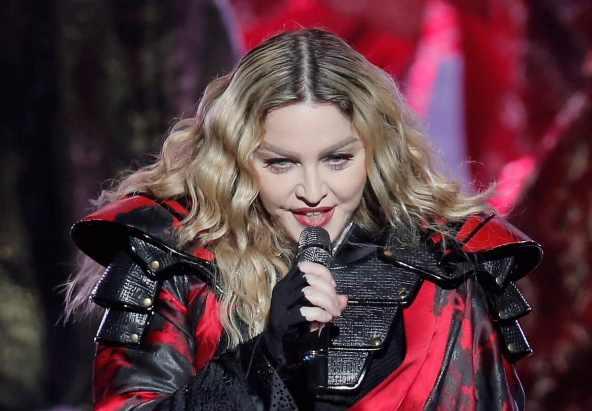 Madonna appears on stage, singing into a microphone