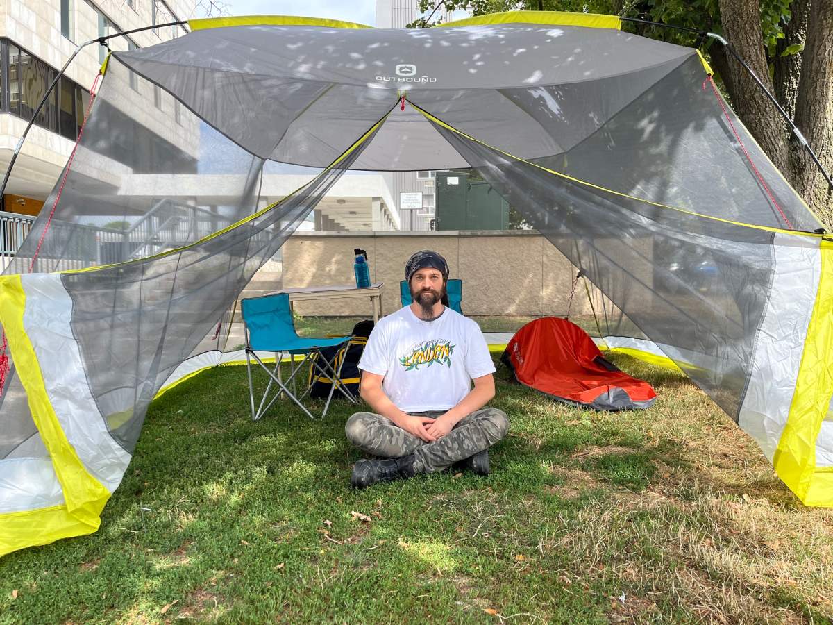 Dan Oudshoorn sits inside the tent near City Hall where he will carry out a hunger strike on behalf of The Forgotten 519.