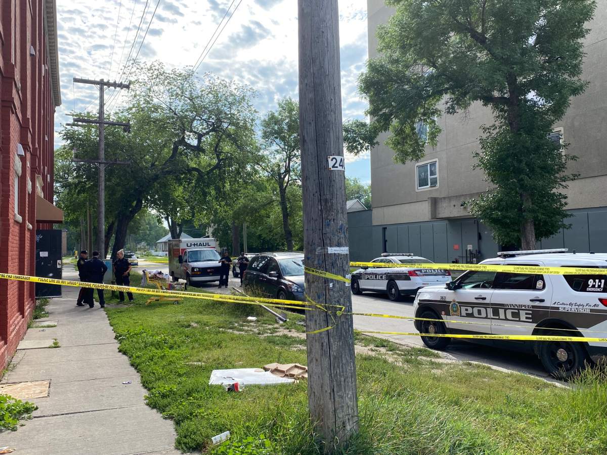Winnipeg police outside the Jarvis Avenue apartment building where Danielle Dawn Ballantyne's body was found, Aug. 22, 2022. On Sunday morning, police announced they had arrested the second teen suspected wanted in connection to her murder. The news comes a day after Ballantyne's family held a vigil at the site.