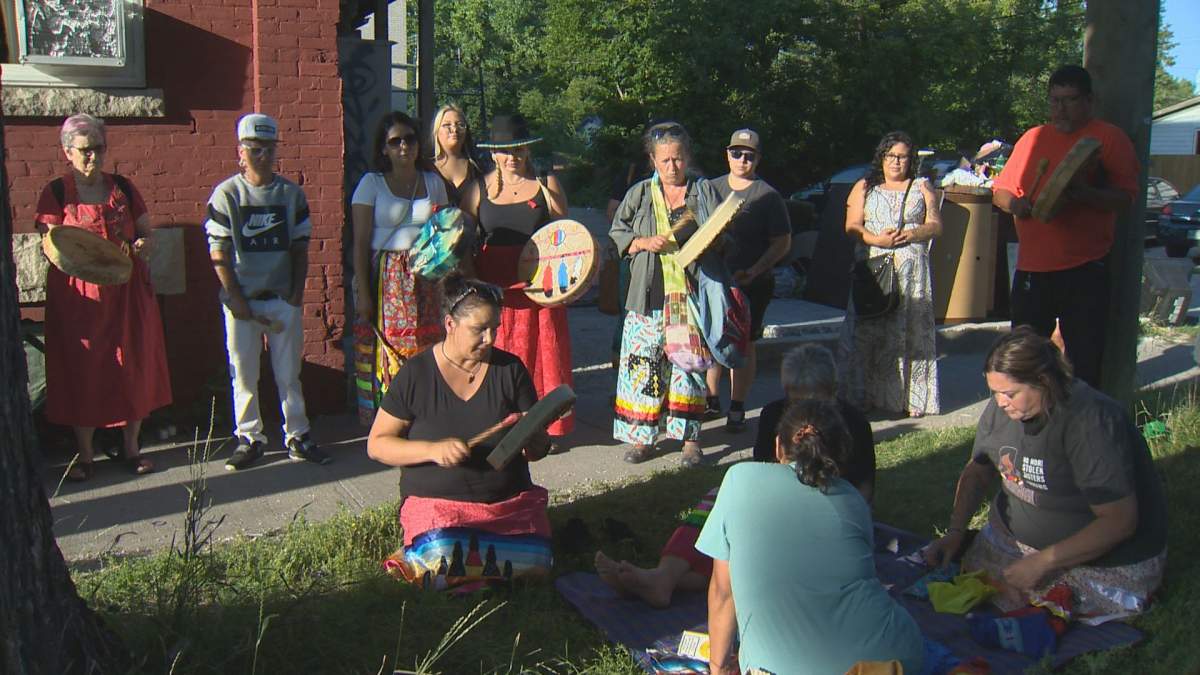 Family, friends and members of the community play a traditional Indigenous song at the evening vigil honouring Danielle Ballantyne on Aug. 27, 2022.