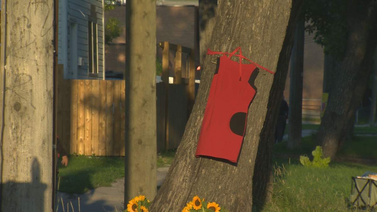 A red dress honouring missing and murdered Indigenous women and girls hangs outside the Jarvis Avenue apartment building on Aug. 27, 2022, where Danielle Ballantyne’s body was found the week before.