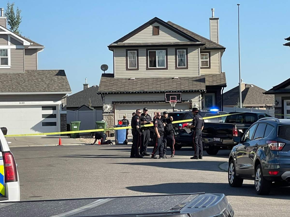 Calgary police block off the 100 block of Everwoods Court S.W.  after a woman died from gunshot wounds and a man was sent to hospital in life-threatening condition on Aug. 18, 2022.