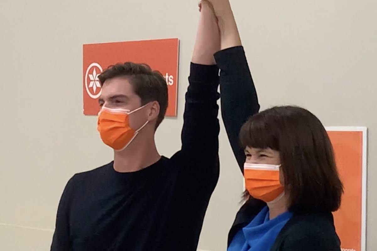 Nathaniel Teed and Carla Beck raise hands in victory.