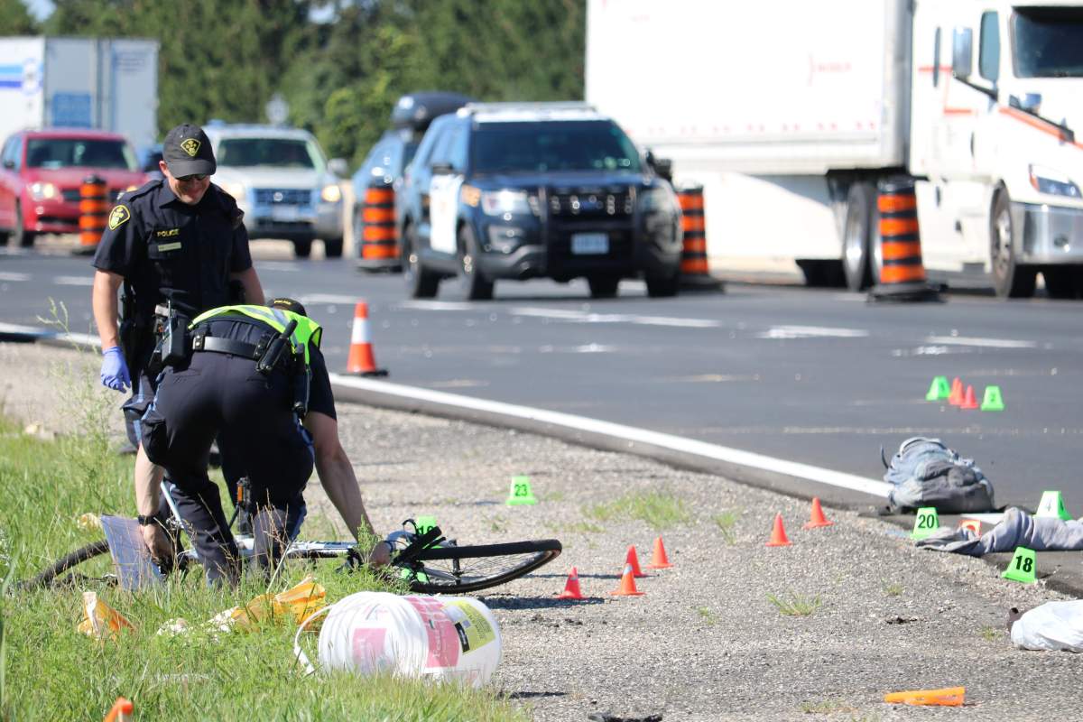 OPP officers investigating a fatal collision on Highway 401 involving a cyclist and a vehicle in the eastbound lane near Colonel Talbot Road, London. August 11, 2022