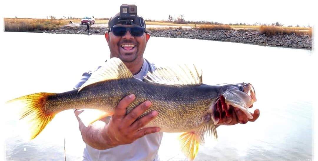 Vlogger, Rajesh John, holding a fish during one of his fishing trips. John died suddenly earlier this month.