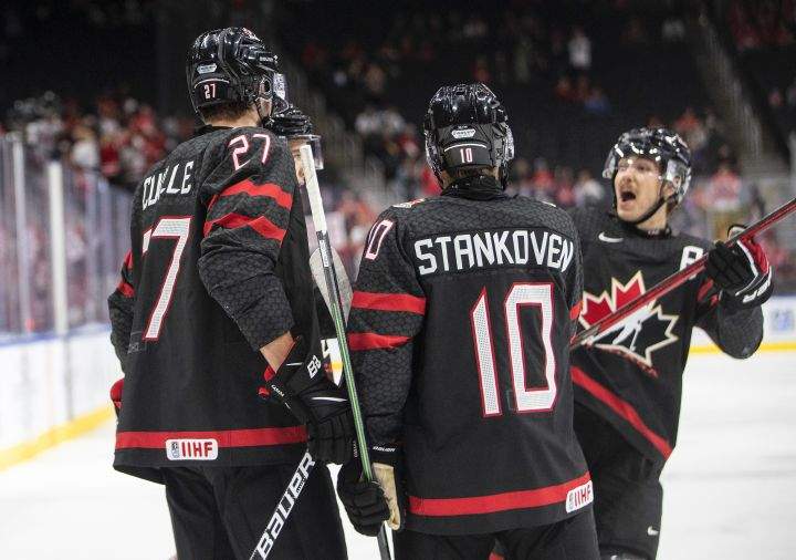 Canada’s Will Cuylle (27), Logan Stankoven (10) and Donovan Sebrango (7) celebrate a goal against Switzerland during second period IIHF World Junior Hockey Championship quarterfinal action in Edmonton on Wednesday August 17, 2022.