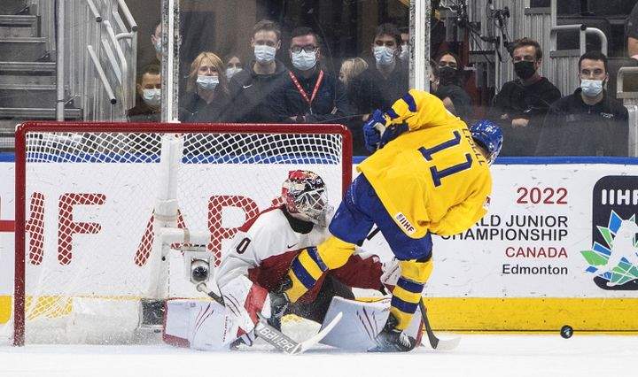 Sweden’s Fabian Lysell (11) is stopped by Austria’s goalie Sebastian Wraneschitz (30) on a penalty shot during third period IIHF World Junior Hockey Championship action in Edmonton on Friday August 12, 2022.