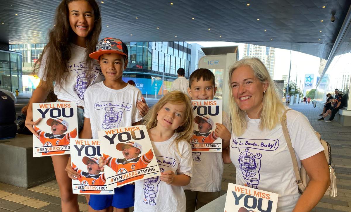 People gather outside Rogers Place Friday, Aug. 19, 2022 as a procession to say farewell to six-year-old Oilers fan Ben Stelter passes by.