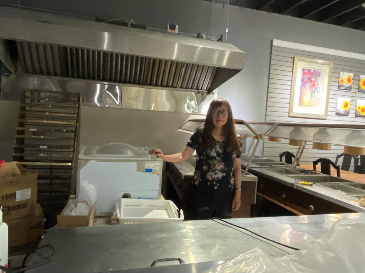 Christina Lo in front of unused equipment
