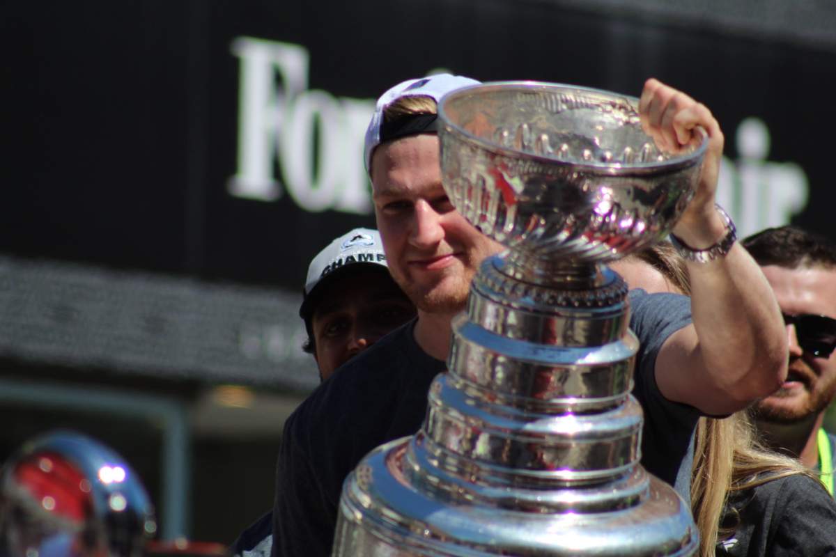Nathan MacKinnon holds the Stanley Cup during a parade in downtown Halifax.