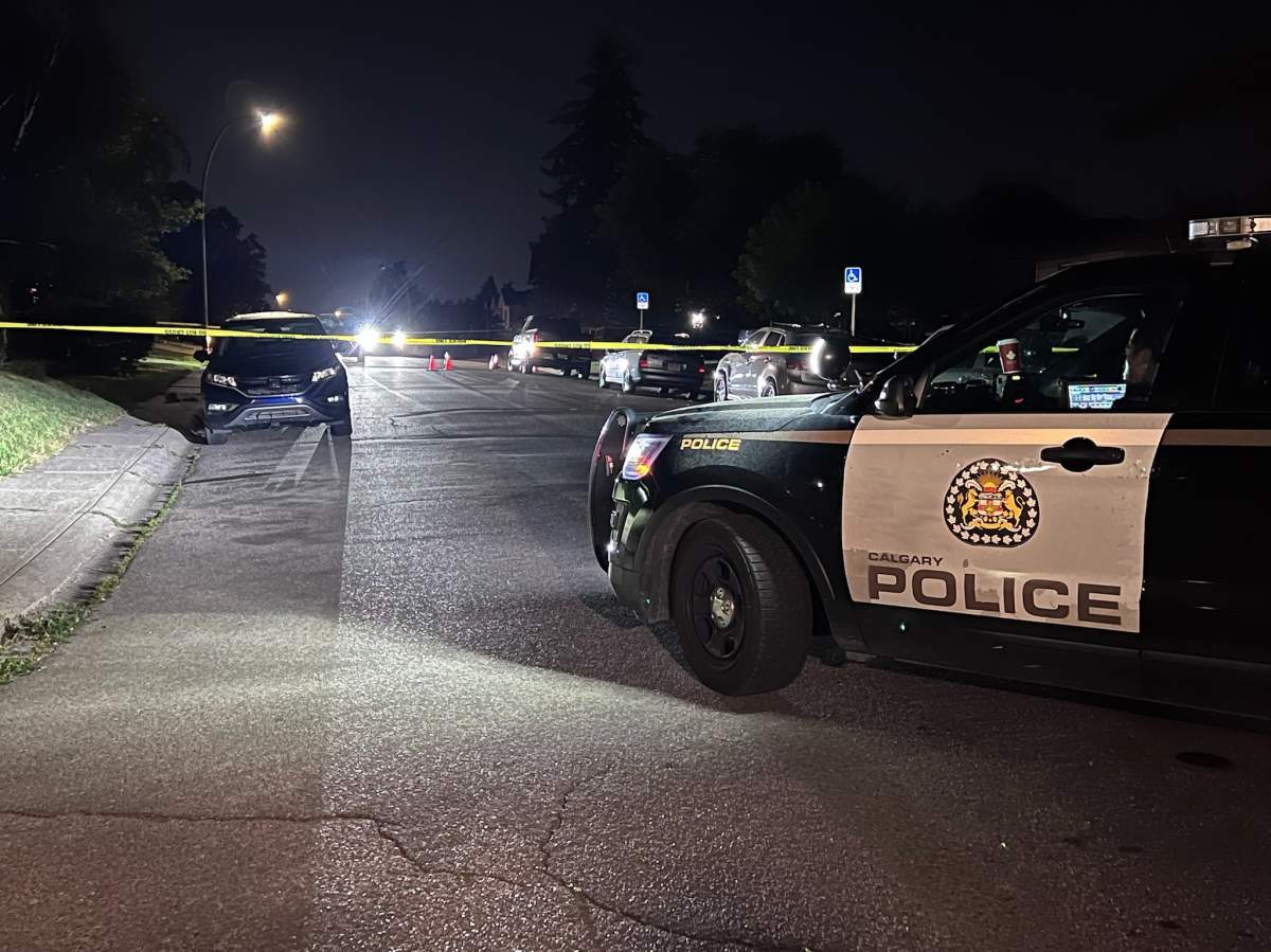 Calgary Police vehicles and tape at the scene of an officer-involved shooting