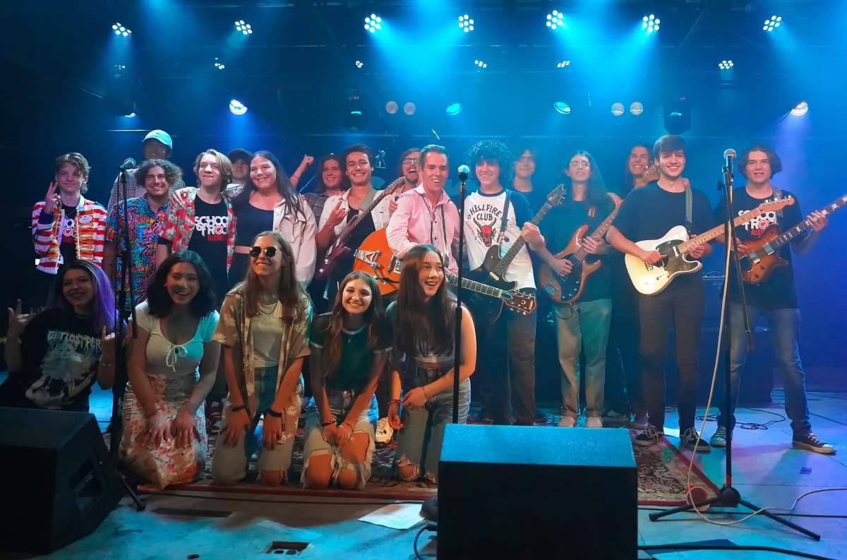Kennedy Pisula(4th from left) is joined on stage by fellow School of Rock All-Stars in Denver, Colorado.