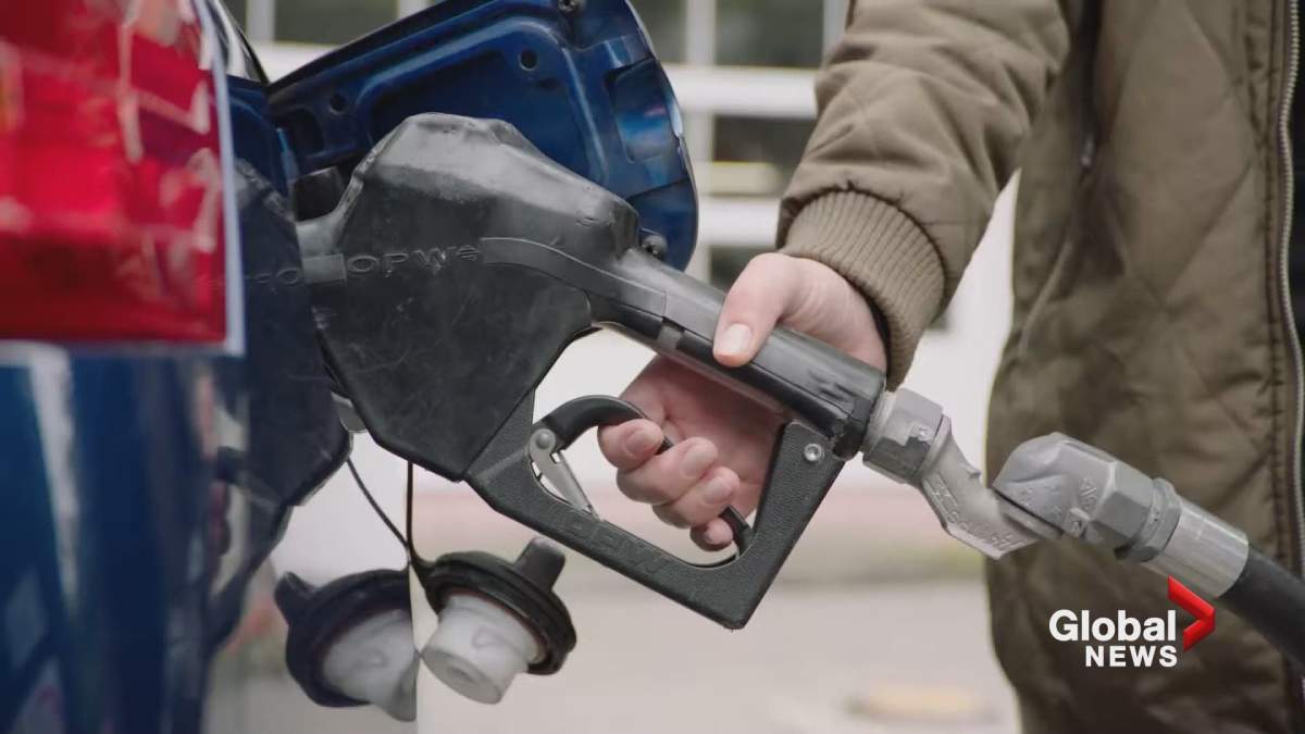 A motorist pumps gas.