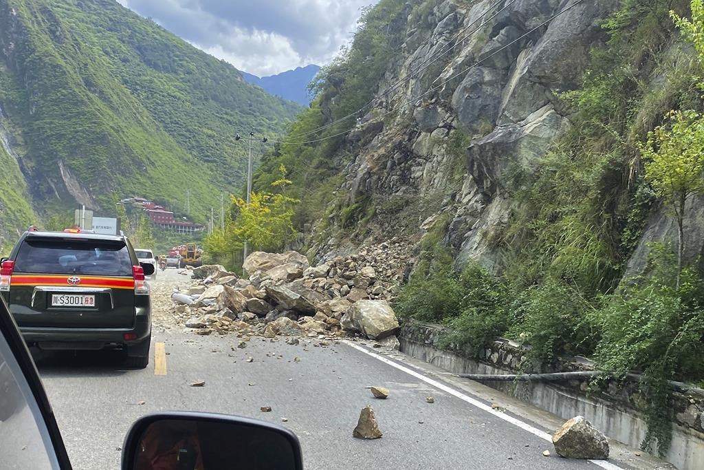 In this photo released by Xinhua News Agency, fallen rocks are seen on road heading to Luding county, the epicentre of a quake in southwest China’s Sichuan Province on Sept. 5. – Xinhua via AP