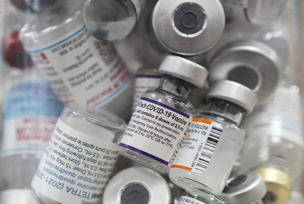 A jar full of empty COVID-19 vaccine vials is shown at the Junction Chemist pharmacy during the COVID-19 pandemic in Toronto on April 6, 2022. THE CANADIAN PRESS/Nathan Denette.
