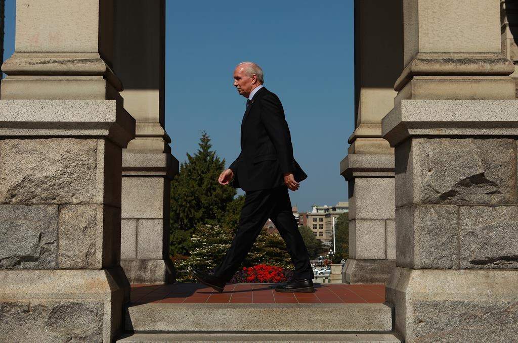 Premier John Horgan makes his way back to his office after his visit to the Hall of Honour to sign a book of condolence for Queen Elizabeth II while at the legislature in Victoria, B.C., on Monday, September 12, 2022. Dignitaries including the premier and Lt.-Gov. Janet Austin have joined a commemorative service in honour of Queen Elizabeth II in the capital city named after her great-great-grandmother.THE CANADIAN PRESS/Chad Hipolito.