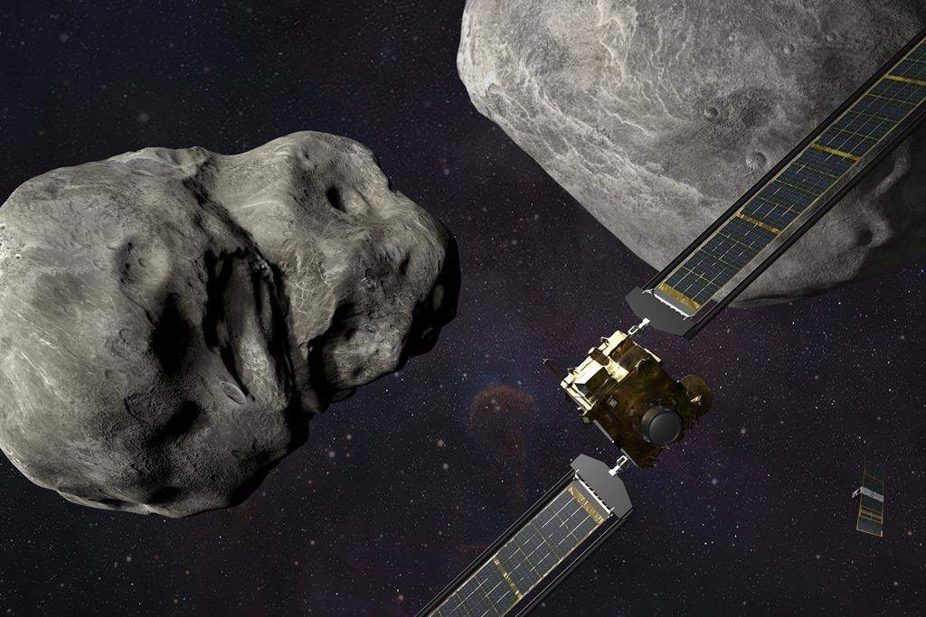 This illustration made available by Johns Hopkins APL and NASA depicts NASA's DART probe, foreground right, and Italian Space Agency's (ASI) LICIACube, bottom right, at the Didymos system before impact with the asteroid.