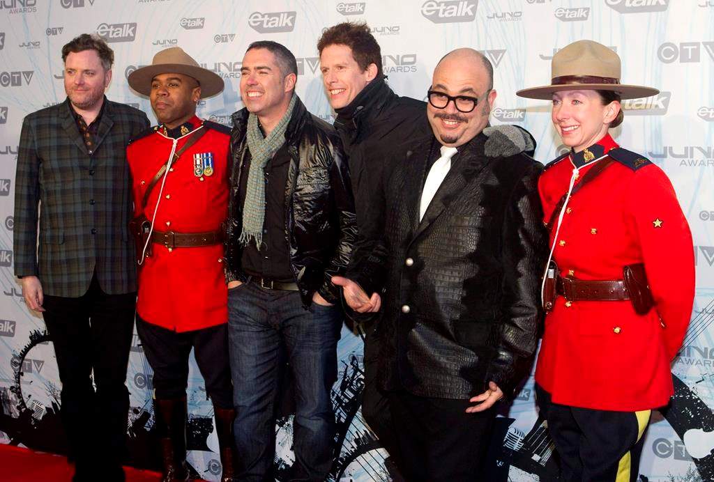 The Barenaked Ladies pose with two Mounties on the red carpet at the 2011 JUNO Awards in Toronto on Sunday, March 27, 2011.