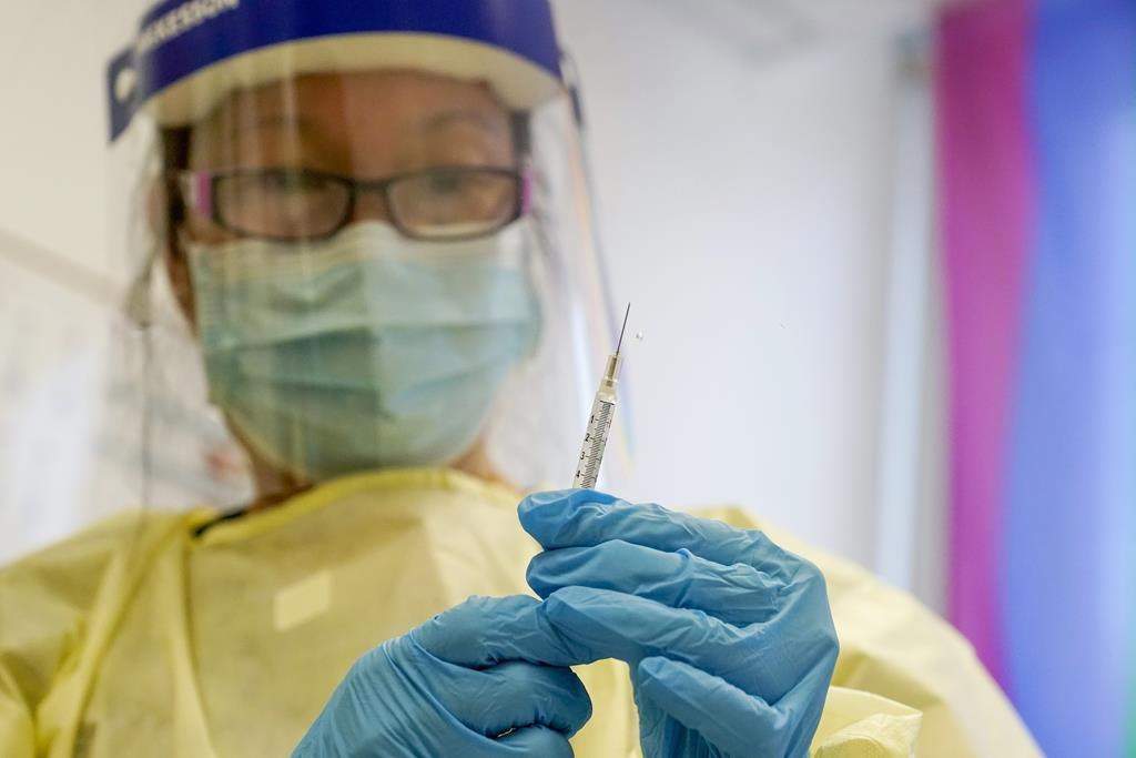 A physician assistant prepares a syringe with the monkeypox vaccine for a patient during a vaccination clinic Friday, Aug. 19, 2022, in New York.